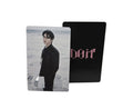 Two cards, one black with text and one with a person's portrait, on a light gray surface.