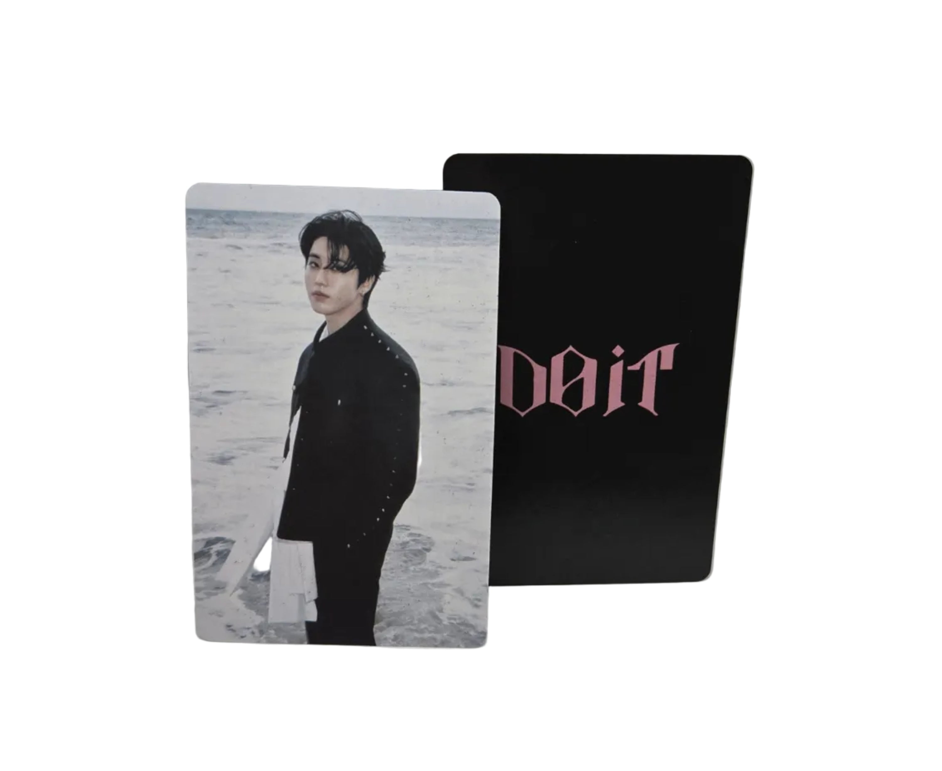 Two cards, one black with text and one with a person's portrait, on a light gray surface.
