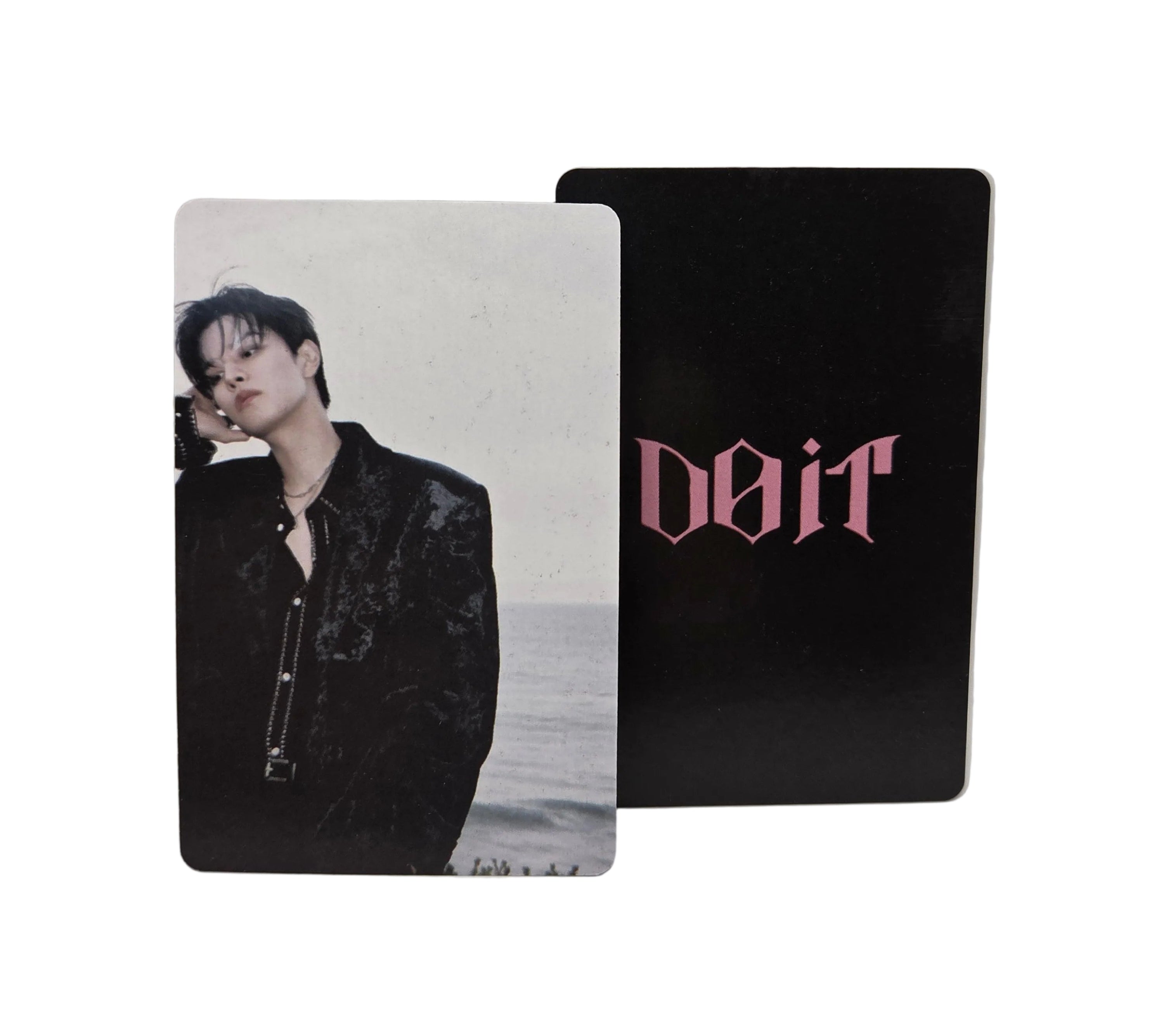 Two cards with a black card featuring pink text and a photo card of a person on a white background