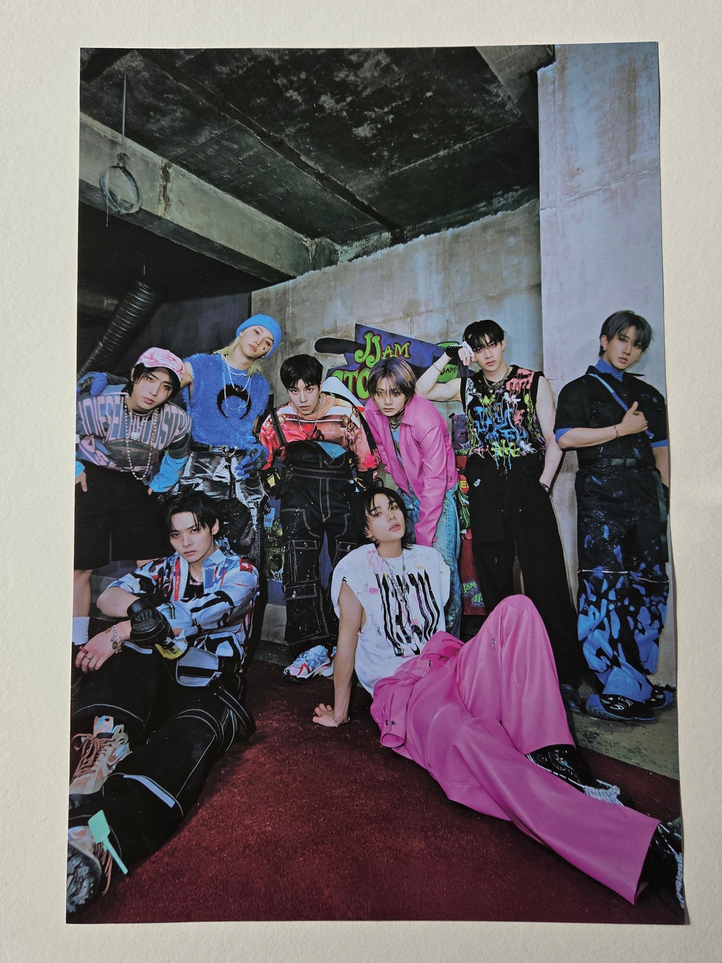 Group of people in formal attire on a red carpet with a large mirror reflecting the scene.
