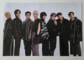 Group photo of seven individuals in formal attire on a white background